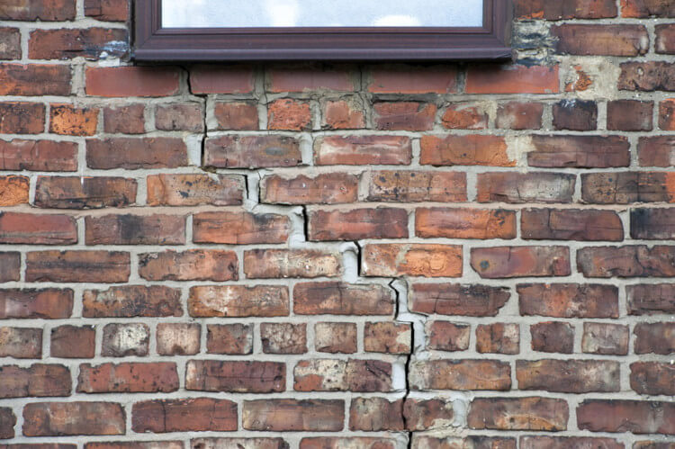 Crack in the wall under a window